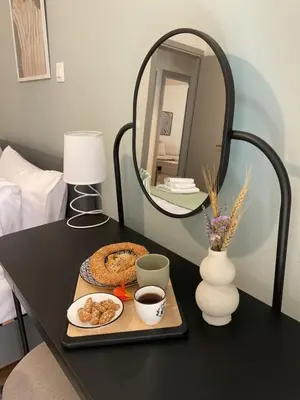 a table with a plate of food and a mirror at CASA 7 urban 3 bedroom apartment in Chania Town