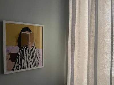 a painting of a woman on a wall next to a window at CASA 7 urban 3 bedroom apartment in Chania Town