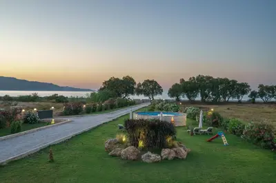 a garden with a playground in the middle of a road at New Beachfront villa Six Stars in Chania,close to the beach & amenities in Kamisianá