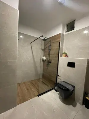 a bathroom with a glass shower with a toilet at Armela in Áyioi Theódhoroi