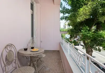 a balcony with a table and chairs and a window at Alba Boutique Hotel in Chania Town