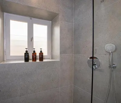 a bathroom with a shower with two bottles on a window at Alba Boutique Hotel in Chania Town