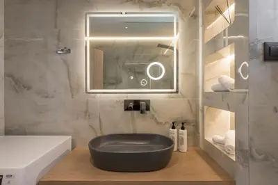a bathroom with a black bowl sitting on a wooden floor at Luna Luxury Living in Tavronitis