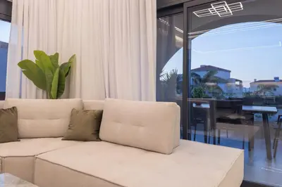 a living room with a white couch and a table at Luna Luxury Living in Tavronitis