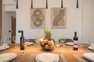 a table with wine glasses and a bowl of fruit at Luna Luxury Living in Tavronitis