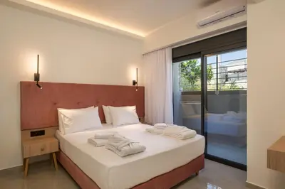 a bedroom with a bed with towels on it at Luna Luxury Living in Tavronitis