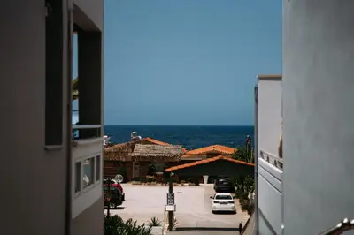 a view of the ocean from a building at Kalamaki del mar apartments in Galatás
