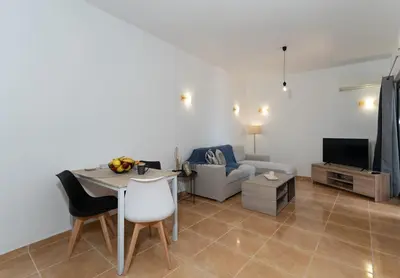 a living room with a table and a couch at Kalamaki del mar apartments in Galatás