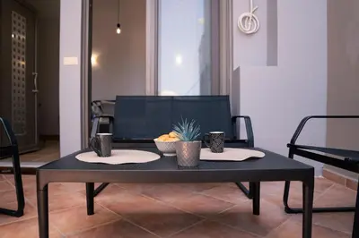 a black table with a bowl of fruit on it at Kalamaki del mar apartments in Galatás