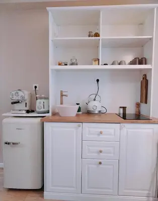 a kitchen with white cabinets and a counter top at RosaMaria's Garden in Kounoupidhianá