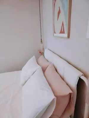 a white couch in a white room with pillows at RosaMaria's Garden in Kounoupidhianá
