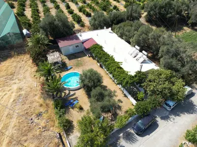an overhead view of a house with a swimming pool at Panos Appartments in Palaiochóra