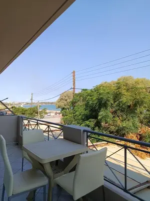 a balcony with a table and chairs and a view at By the sea in Chania Town