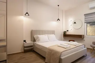 a bedroom with a bed with two towels on it at 2BR Central Chania, Steps to Koum Kapi & Old Town in Chania Town