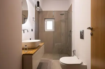 a bathroom with a sink and a toilet and a shower at 2BR Central Chania, Steps to Koum Kapi & Old Town in Chania Town