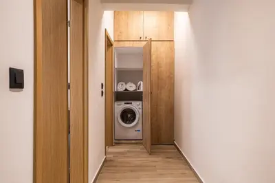 a hallway with a washer and dryer in a room at 2BR Central Chania, Steps to Koum Kapi & Old Town in Chania Town