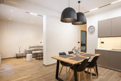 a kitchen and dining room with a table and chairs at 2BR Central Chania, Steps to Koum Kapi & Old Town in Chania Town