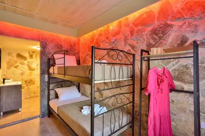 a room with bunk beds and a wall with a mural at Villa Ravdoucha in Ravdhoúkha