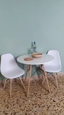 two white chairs and a white table and a table and chairs at Chania ELIA apARTment Chalepa in Chania Town