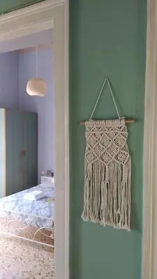 a bedroom with a bed and a curtain on a wall at Chania ELIA apARTment Chalepa in Chania Town