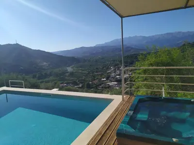 a swimming pool with a view of the mountains at Villa Orgoni in Plataniás