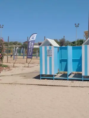 a blue and white building on a beach at Stylish summer flat, close to beach in Daratso