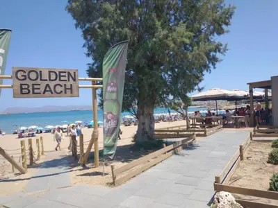 a beach with a sign that reads golden beach at Stylish summer flat, close to beach in Daratso