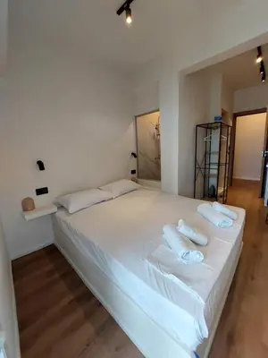 a white bed with two pillows on top of it at Chavalon Apartments in Kalyves