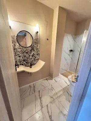 a bathroom with a mirror and a sink and a toilet at Chavalon Apartments in Kalyves
