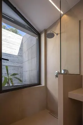 a bathroom with a shower with a large window at Salisol Villa - Green Oasis in Chania Town