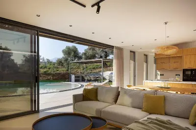 a living room with a couch and a table at Salisol Villa - Green Oasis in Chania Town