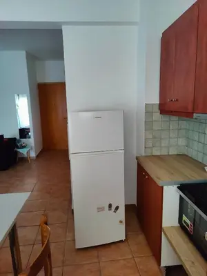 a kitchen with a white refrigerator in a room at Nikolaos central cozy apartment & free parking in Chania Town