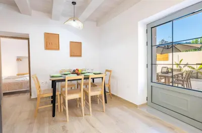 a dining room with a table and chairs at Roots Villa in Skinés