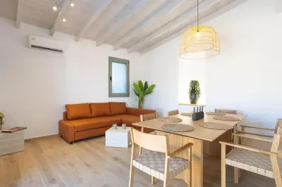 a living room with a table and a couch at Roots Villa in Skinés