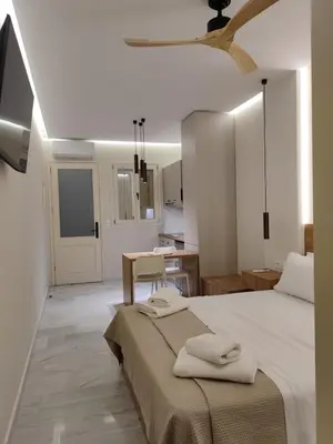 a bedroom with a bed with two towels on it at Dabia Escape in Chania Old Town in Chania Town