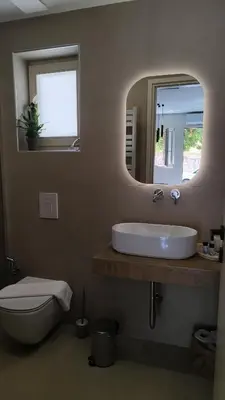 a bathroom with a sink and a toilet and a mirror at Dabia Escape in Chania Old Town in Chania Town