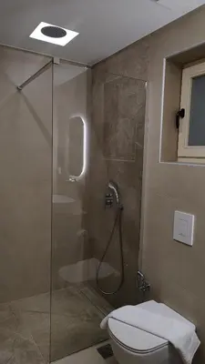 a bathroom with a shower with a toilet and a sink at Dabia Escape in Chania Old Town in Chania Town