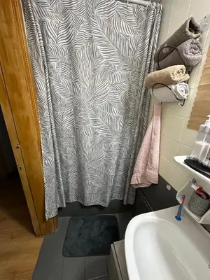 a bathroom with a shower curtain and a sink at Chania City Center Apartment with Balcony Central Aircon in Chania Town