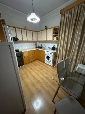 a living room with a kitchen with a washer at Chania City Center Apartment with Balcony Central Aircon in Chania Town