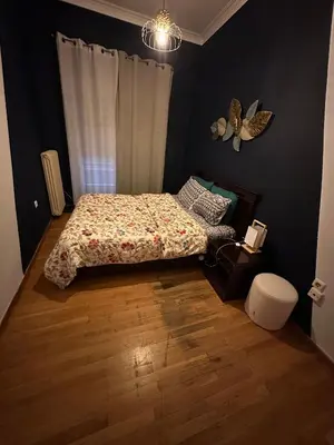 a bedroom with a bed with a butterfly on the wall at Chania City Center Apartment with Balcony Central Aircon in Chania Town