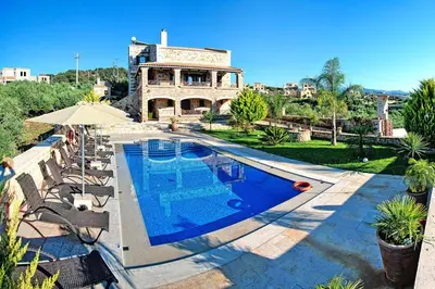 a swimming pool in front of a house at Cretan Villa Near Beach for 10 in Kondomari