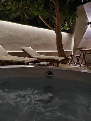a pool with chairs and a tree and a table at Dimora Cozy Retreat in Chania Old Town in Chania Town
