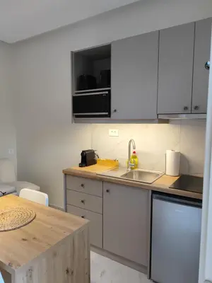 a kitchen with white cabinets and a sink at Dimora Cozy Retreat in Chania Old Town in Chania Town