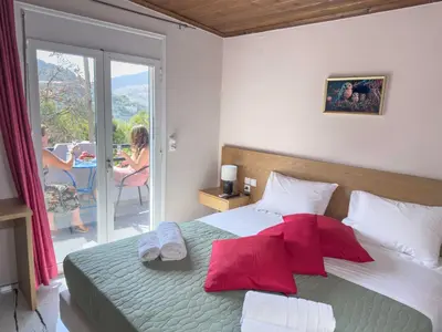 a bedroom with a bed with red pillows on it at Suites Near Elafonisi in Élos