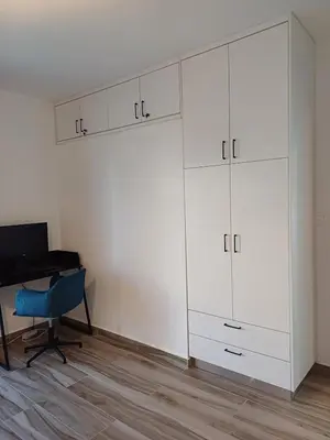 a room with a desk and a white cabinet at Wave Loft in Chania Town
