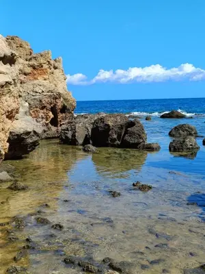 a view of the ocean with rocks in the water at Wave Loft in Chania Town