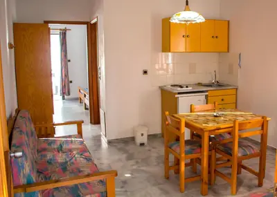 a kitchen and dining room with a table and chairs at Popi Hotel Apartments in Agia Marina Nea Kydonias