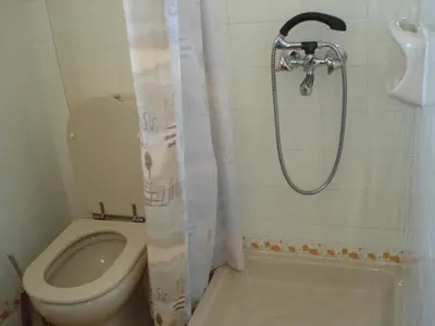 a bathroom with a shower and a toilet and a sink at Popi Hotel Apartments in Agia Marina Nea Kydonias