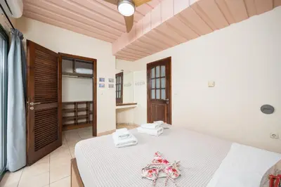 a bedroom with a white bed with towels on it at Aloni Villa in Káïna