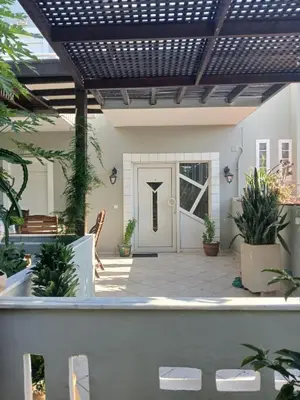 a patio with a door with plants and a fence at Villa Esperado Gardens Maleme in Maleme
